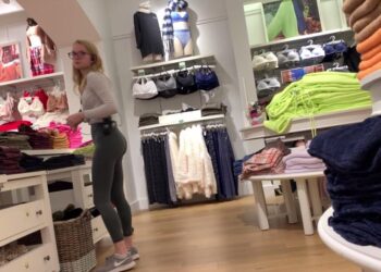 blonde in tight green leggings clothing store voyeur
